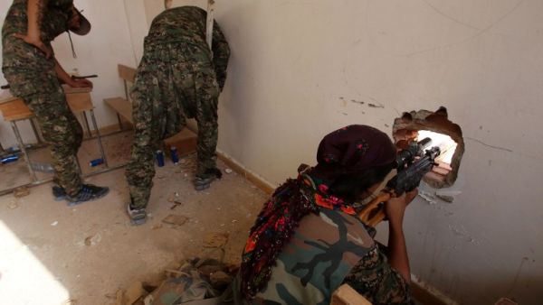 Kurdish YPG forces take position inside a classroom during clashes with Daesh militants. (AFP/File) Kurdish YPG forces take position inside a classroom during clashes with Daesh militants. (AFP/File)