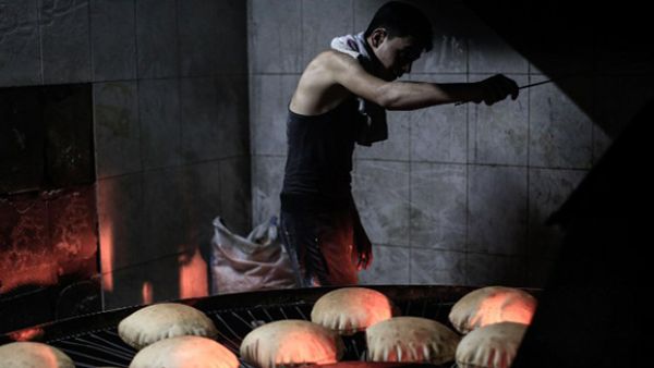 A Syrian man works at a bakery in the rebel-held town of Douma, east of the capital Damascus . (AFP/File)