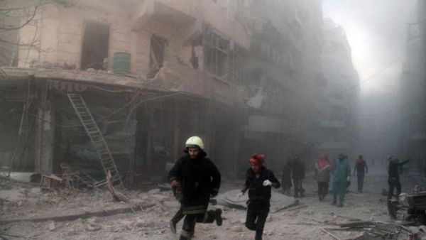 Emergency responders rush following a reported barrel bomb attack by government forces in 2014. (AFP/Tamer al-Halabi)