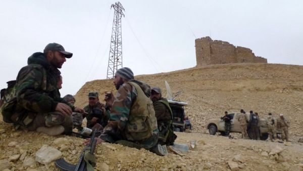 Syrian pro-government forces rest next to the Palmyra citadel on March 26, 2016, during a military operation to retake the ancient city from Daesh.  (AFP/Maher al-Mounes)
