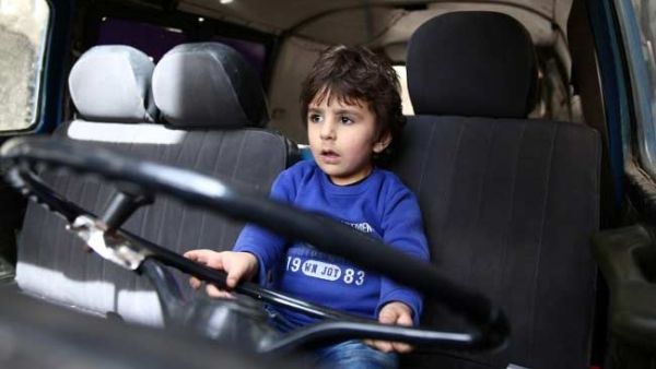 A boy plays in a vehicle (AFP/File Photo)