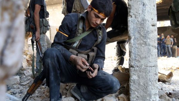 A rebel fighter reloads the magazine of his weapon during clasahes with regime forces in Ramussa on the southwestern edges of Syria's northern city of Aleppo on August 6, 2016. (AFP/Hadi Al-Falabi)