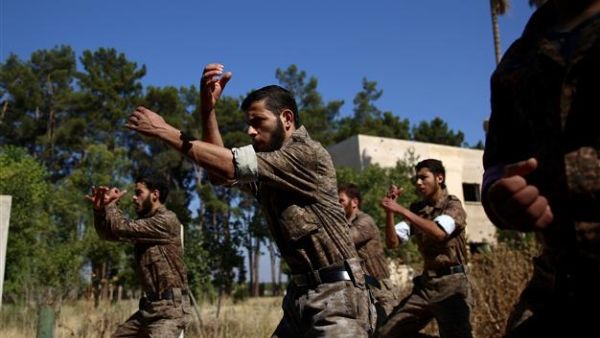 Rebel fighters who recently joined the Failaq al-Rahman brigade take part in a training session at a camp in Syria's rebel-held Eastern Ghouta region before being sent to the front lines, on July 11, 2015. (AFP/File)