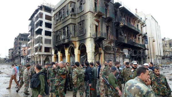 Syrian Arab Army soldiers stand in the streets of Homs. (AFP/File)