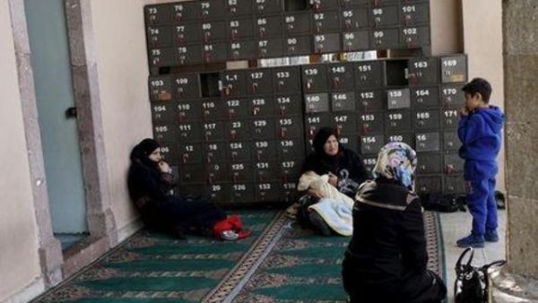 نساء سوريات يجلسن عند مدخل أحد المساجد في ازمير بتركيا
