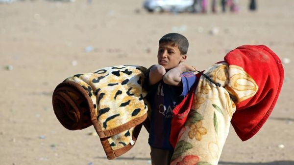 An Iraqi refugee boy fleeing Mosul (AFP/File)