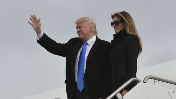US President Donald Trump and his wife Melania step off a plane upon arrival at Andrews Air Force Base in Maryland on January 19, 2017. (AFP/ Mandel Ngan)