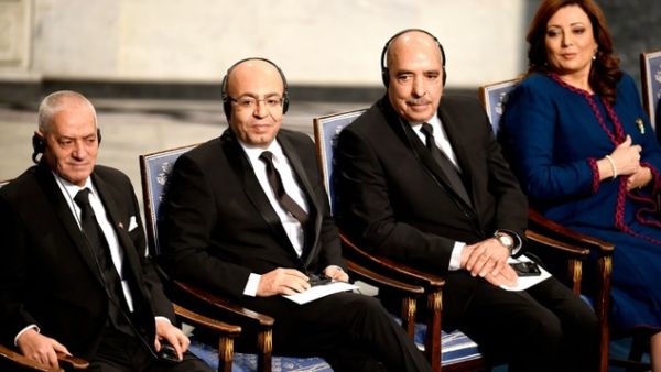 Tunisian National Dialogue Quartet member, Abdessatar Ben Moussa (R) receives the 2015 Nobel Prize medal as fellow Dialogue Quartet members, Houcine Abbassi (L) and Mohamed Fadhel Mahfoudh (2nd L) look on at the ceremony in Oslo on December 10, 2015. (AFP/Odd Andersen)