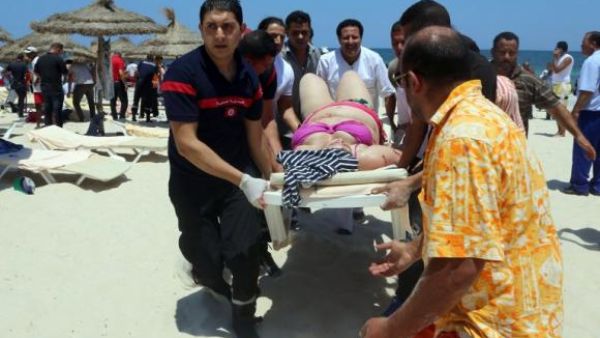 Tunisian medics carry a woman on a stretcher in the resort town of Sousse, south of the Tunisian capital. (AFP/File)