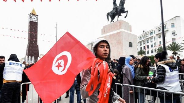  Tunisian boy holding a national flag (AFP/File Photo)