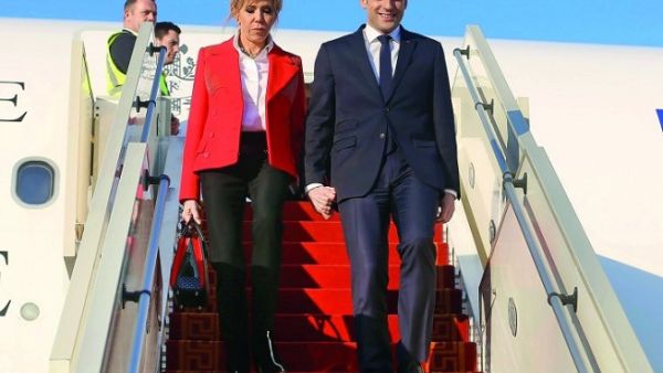French President Emmanuel Macron and his wife Brigitte Macron descend from an airplane upon their arrival at Tunis-Carthage International Airport on January 31, 2018. (Zoubeir Souissi/ AFP)
