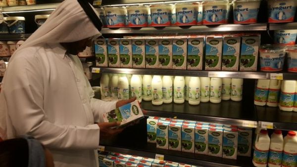 A customer reads the label on a Turkish dairy product at a supermarket in Doha. (The Peninsula)