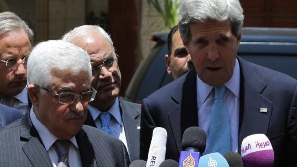 US Secretary of State John Kerry speaks to the press with Palestinian president Mahmoud Abbas following their meeting in the West Bank city of Ramallah (Abbas Momani / AFP)