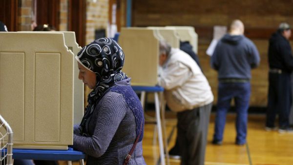 An American Muslim woman votes at the recent election (AFP)