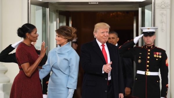 President-elect Donald Trump gives a thumbs up as he and his wife Melania are greeted by US President Barack Obama and First Lady Michelle Obama as they arrive at the White House in Washington, DC January 20, 2017. (AFP/Jim Watson)