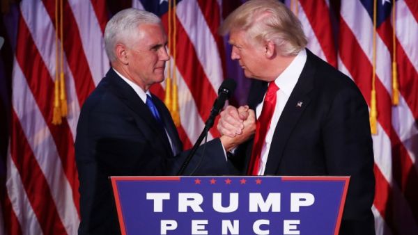 Vice president-elect Mike Pence and Republican president-elect Donald Trump shake hands during his election night event at the New York Hilton Midtown in the early morning hours of November 9, 2016 in New York City. (AFP/Mark Wilson)