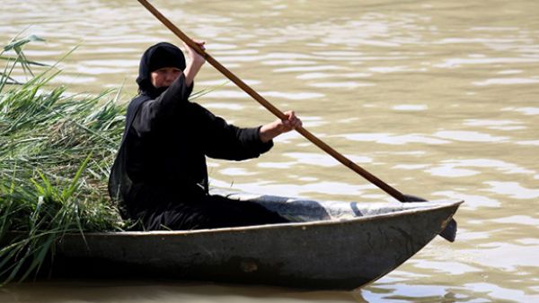 An Iraqi woman rides a boat in the Ahwar area in the southern Maysan province -- also known as the Iraqi Marshlands -- one of the world's largest inland delta systems. (AFP/File)