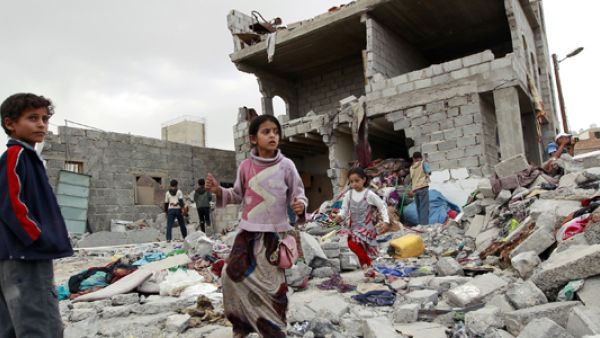 Children walk through the rubble after an airstrike in Yemen. (AFP/File)