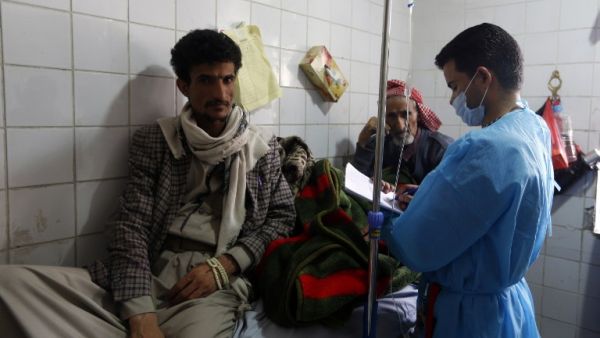 Yemeni men suspected of being infected with cholera receive treatment at a hospital in Sanaa on May 12, 2017. (AFP/Mohammed Huwais)
