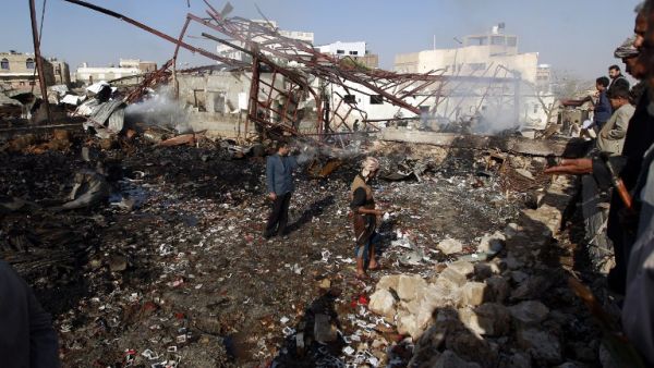Yemenis inspect the damage at a sewing workshop that was hit by a Saudi-led coalition air strike in the capital Sanaa, on February 14, 2016. (AFP/Mohammed Huwais)