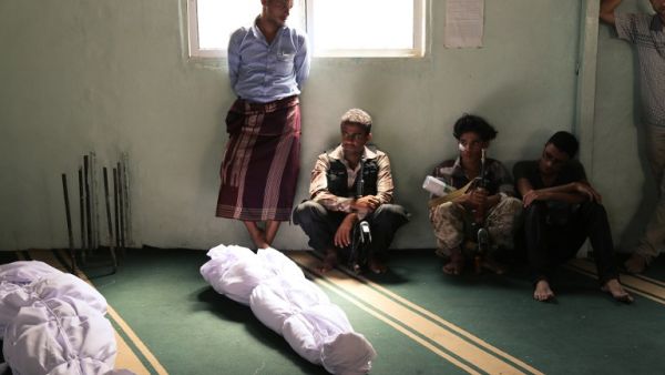 Yemenis mourn next to the bodies of victims who were killed in a rocket attack in a Taiz market during clashes between Hadi loyalists and Houthi rebels on Sept. 20, 2015. (AFP/Ahmad al-Basha)