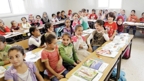Syrian children sit in a classroom at the Zataari refugee camp. (AFP/File)
