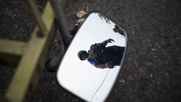 A Sri Lankan soldier is reflected on a mirror as he mans his position at a checkpoint in Colombo (AFP)