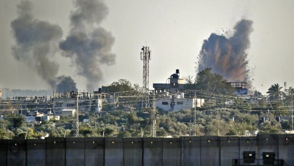A picture taken from the southern Israeli village of Netiv Haasara shows an explosion and smoke fumes caused by an Israeli airstike across the border in the Gaza Strip (AFP)
