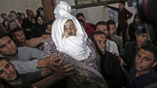 Palestinian mourners carry the shrouded body of Saba Abu Arar during her funeral in Gaza City (AFP)