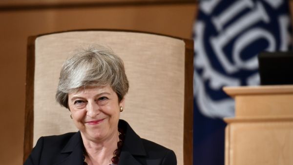 Britain's outgoing Prime Minister Theresa May smiles after delivering her speech at the ILO International Labour Conference on June 11, 2019 in Geneva.  FABRICE COFFRINI / AFP