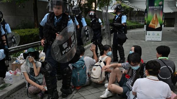 Police walk among protesters during a rally against a controversial extradition law proposal in Hong Kong on June 12, 2019 (AFP)
