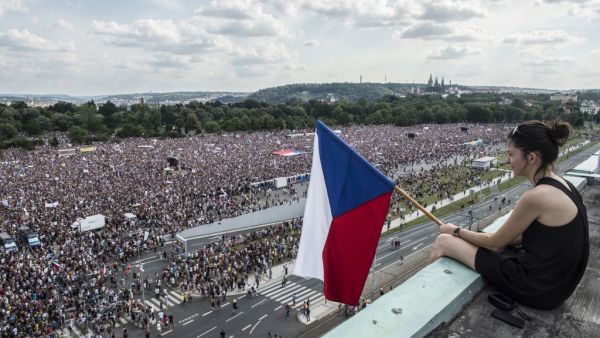 A woman holds a Czech flag during a rally demanding the resignation of Czech Prime Minister Andrej Babis (AFP)