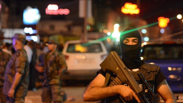 Tunisian security forces tighten security measures outside a metro station near the bus stop where a man reportedly wearing an explosive belt blew himself up in the early hours (AFP)