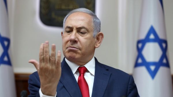 Israeli Prime Minister Benjamin Netanyahu looks at his hand as he chairs the weekly cabinet meeting at his office in Jerusalem on July 7, 2019.  ABIR SULTAN / POOL / AFP