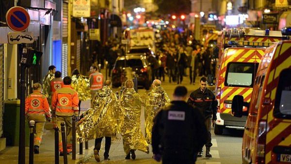 People being evacuated on rue Oberkampf near the Bataclan concert hall in central Paris (AFP)