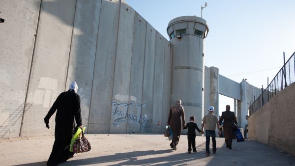 Palestinian women pass through the Bethlehem checkpoint (Shutterstock)	