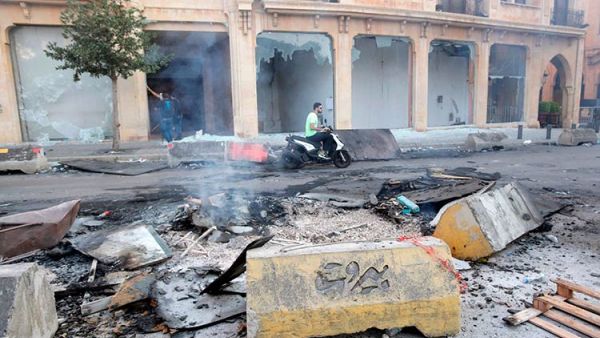 A Lebanese motorist drives past debris at Riad Al Solh Square in the centre of the capital Beirut. Anwar Amro/AFP