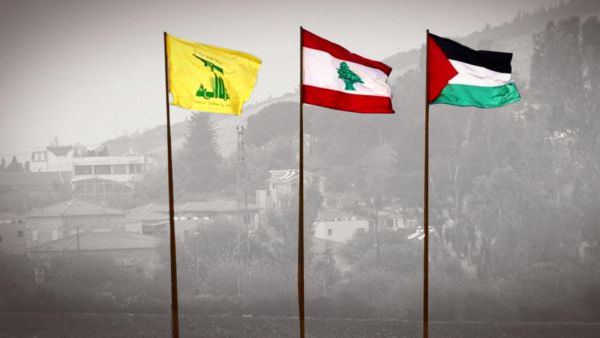 The flags of Lebanon’s Hezbollah resistance movement (L), Lebanon (C), and Palestine flying near the southern Lebanese village of Kfar Kila /AFP