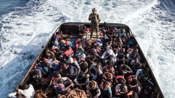 A Libyan coast guard watches over a boat of rescued migrants on  June 27, 2017 /AFP