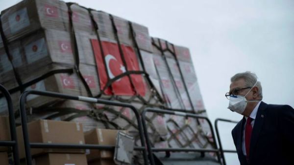 Turkey’s US, Ambassador Serdar Kilic watches as medical supplies arrive in the US in April /AFP