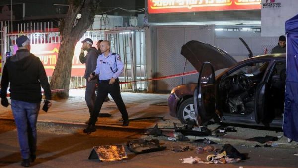 Israeli security forces gather at the site of an attack that left two Israeli police dead in the northern city of Hadera on March 27, 2022. The Magen David Adom emergency medical responders said that "two Israelis" were killed in the attack, with four other people taken to hospital and two more treated at the site. As Sunday's attack took place, Foreign Minister Yair Lapid was hosting his counterparts from three Arab states that recently normalised ties with Israel, alongside Egypt's top diplomat and the US secretary of state, at a resort in southern Israel, in a gathering that Israel called "historic". (Photo by GIL COHEN-MAGEN / AFP) ISIS Claims Responsibility for Israel Terrorist Attack