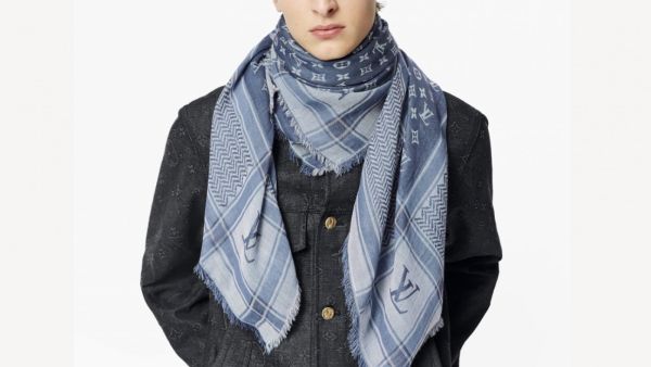 The brand is offering a blue checkered wrap-up decorated with Louis Vuitton’s monogram design and the distinctive cultural pattern. (Twitter) LV Faces Backlash On Social Media Over Keffiyeh-Inspired Scarf