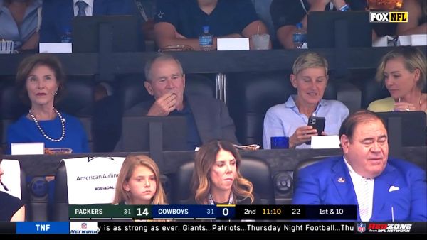 TV host Ellen DeGeneres with the former president of the United States George Bush at an American Football game in Texas.