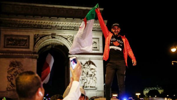 Supporters celebrate after Algeria won the AFCON semi-final match against Nigeria in Paris.