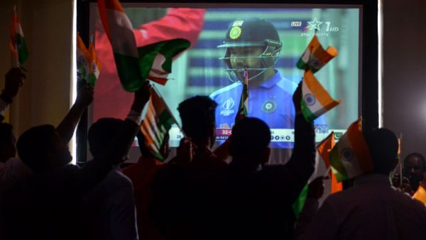 Indian cricket fans react as they watch a live broadcast of the Cricket World Cup match between India and Pakistan at a hotel in Amritsar on June 16, 2019. 