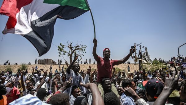 Sudanese protesters shout slogans and wave national flags during a protest outside the army headquarters in the capital Khartoum on April 22, 2019. (AFP/ File)