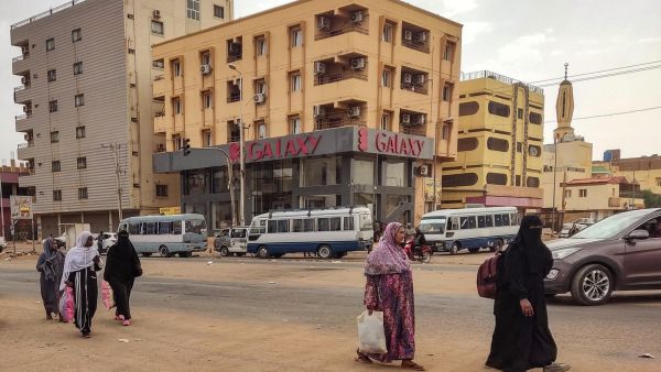 Women walk along a street in the south of Khartoum on April 24, 2023. (Photo by AFP) Sudan