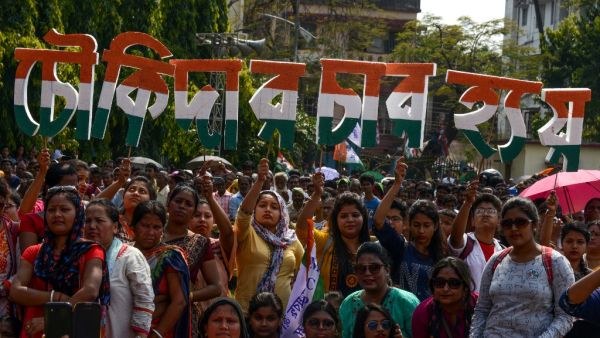 Indian supporters of the Trinamool Congress (TMC) party hold letters forming the slogan of the National Congress, 'Chowkidar Chor Hain' (The watchman is a thief). (AFP)