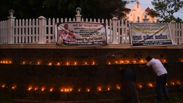 Relatives light a coconut oil lamps and pray for the victims of Easter sunday bomb blasts at St. Sebastian's Church in Negombo, near Colombo on May 4, 2019. (AFP)