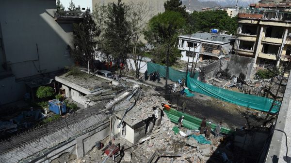 Afghan security forces gather at the site of an attack by Taliban militants, a day after the assault on a compound housing an international aid organisation, in Kabul on May 9, 2019. (AFP)